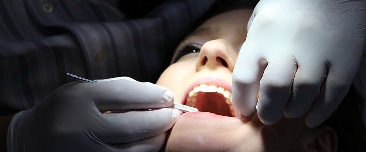 dentist checking a patient's teeth
